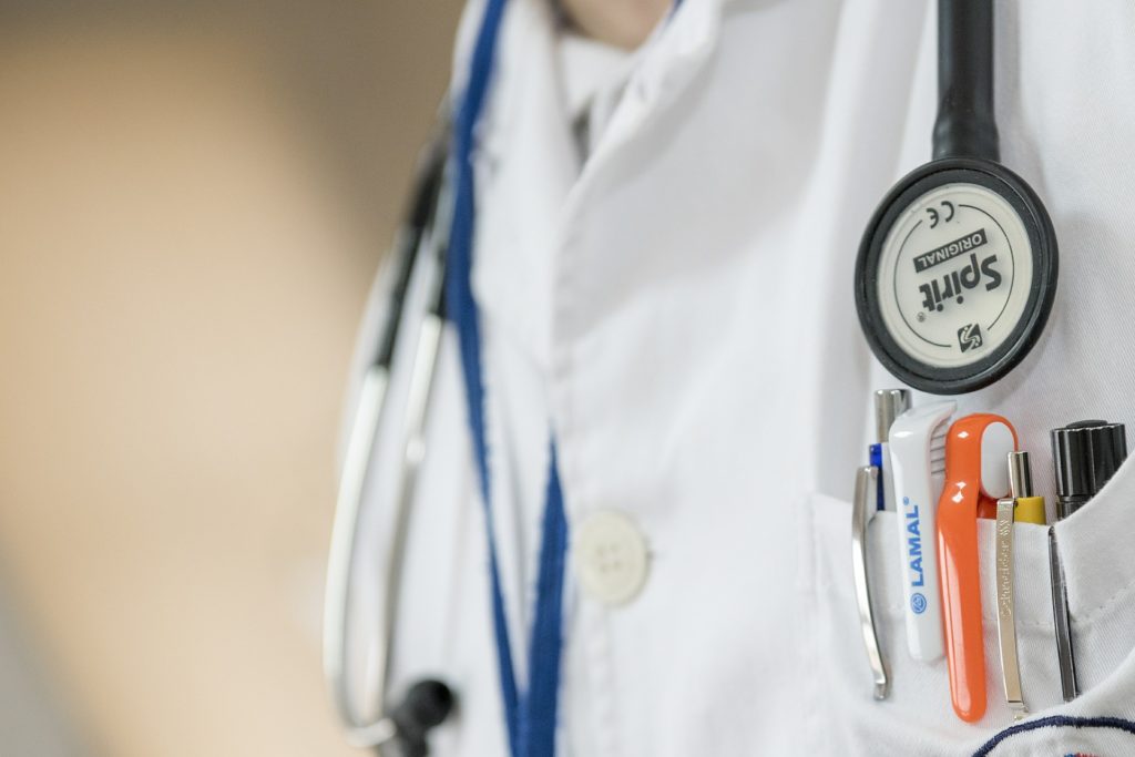 Close-up of medical staff pocket, with stationary and stethoscope 