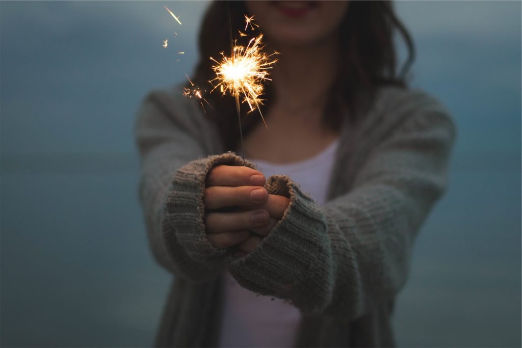 woman holding sparkler. new year.